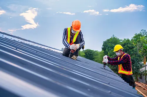 At Your Service Roofing crew installing a metal roof on a home in Shelbyville, IL.