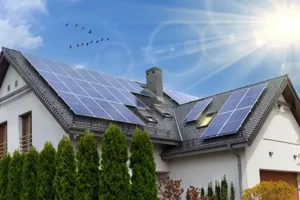 At Your Service Roofing—A home in Taylorville, IL with solar panels on the roof on a sunny day.