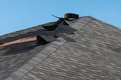 At Your Service Roofing—A wind-damaged roof in Pana, IL, with missing shingles.