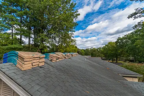 At Your Service Roofing—Shingle bundles are stacked on a roof to prepare for roof replacement services after a recent storm in Springfield, IL.