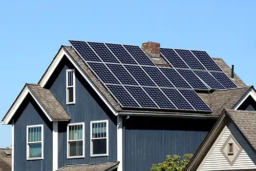 At Your Service Roofing—A residential home in Pana, IL, with solar panels on the roof.