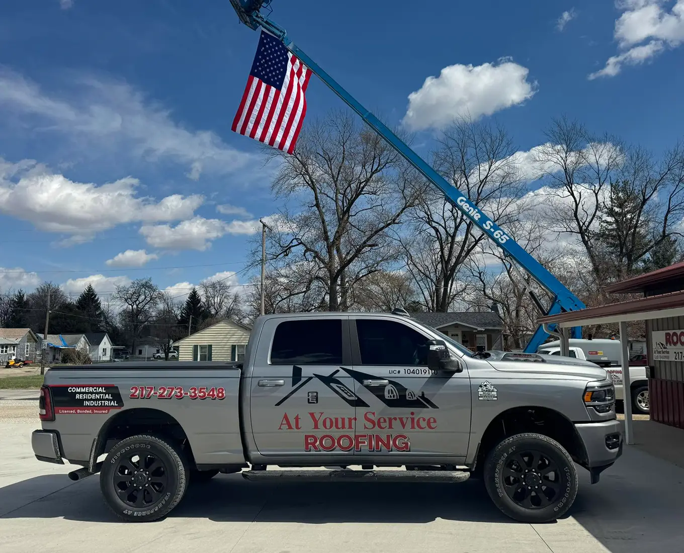 Picture of At Your Service Roofing Central Illinois Professional Roofing Company's Truck and American Flag