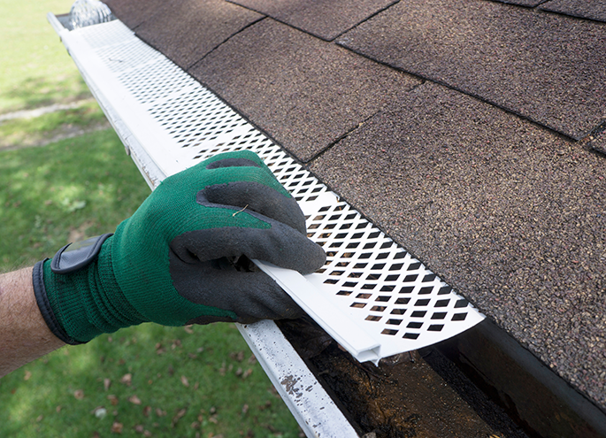 Contractor Adjusting Plastic Gutter Guards central il