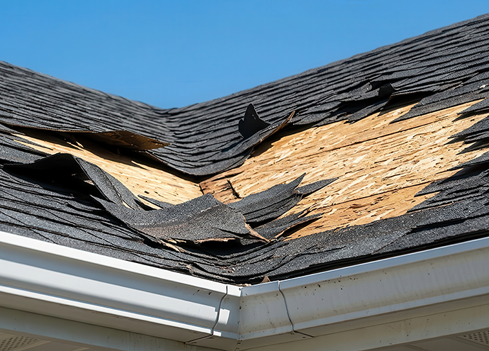 broken asphalt roof with missing shingles and visible wood decking central illinois